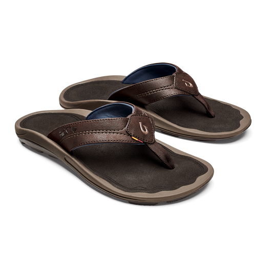Pair of brown leather flip-flop sandals with dark footbeds, navy blue insoles, and tan rubber soles.