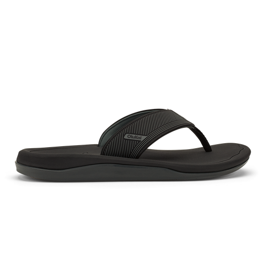Black flip-flop sandal with textured strap and cushioned sole, shown in side profile.