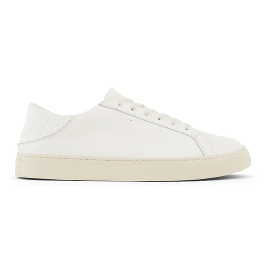 White leather lace-up sneaker with cream rubber sole and textured heel panel.