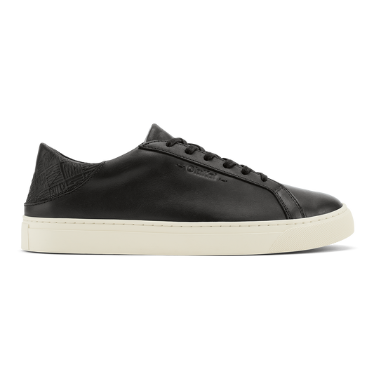 Black leather lace-up sneaker with cream rubber sole and textured heel panel.