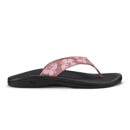 Coral rose flip-flop sandal with black sole and floral patterned upper strap.